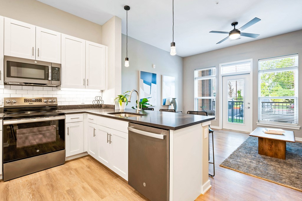 a kitchen with an island and a stove and a microwave