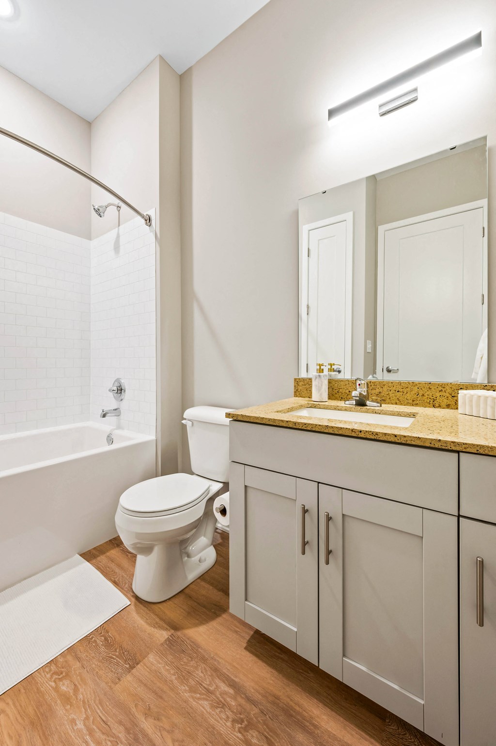 a bathroom with a toilet and a shower and a sink