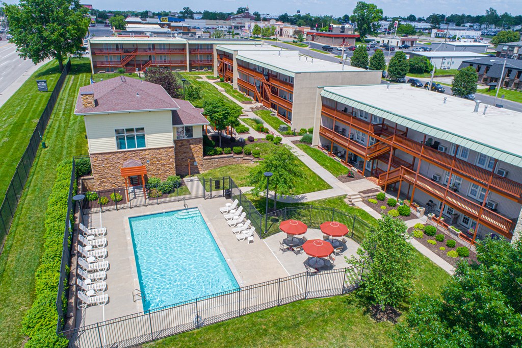 an aerial view of a swimming pool in front of a building
