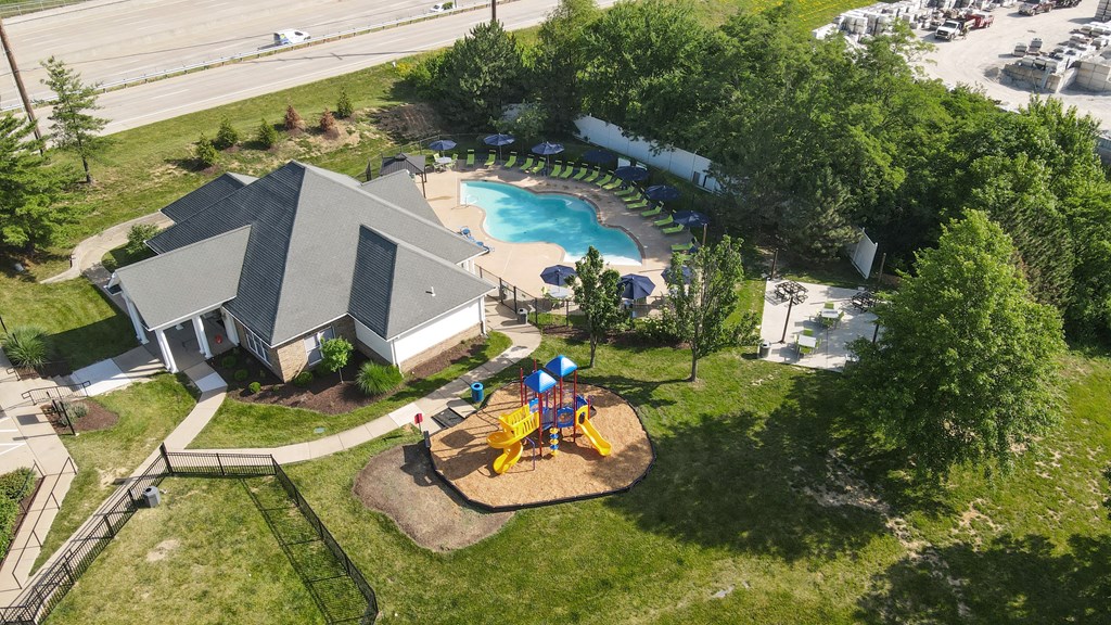an aerial view of a backyard with a swimming pool and picnic table