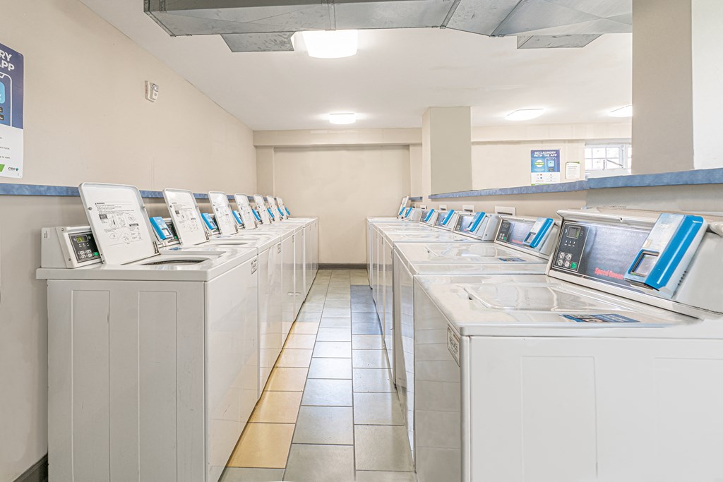 a row of washing machines in a laundry room