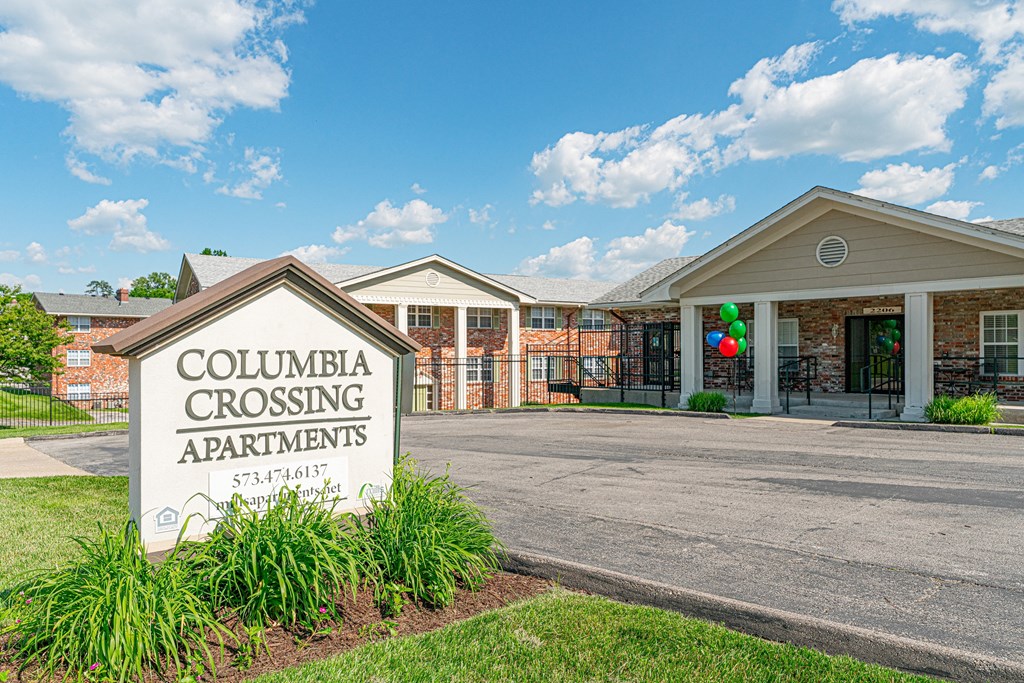 the columbia crossing apartments sign in front of the building