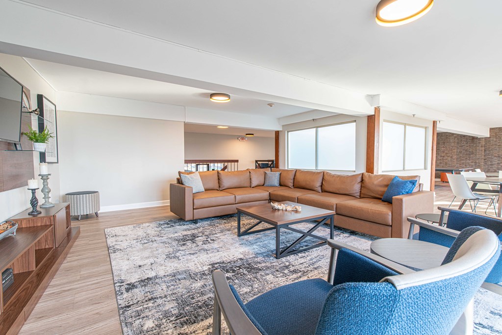 a living room with couches and chairs and a table