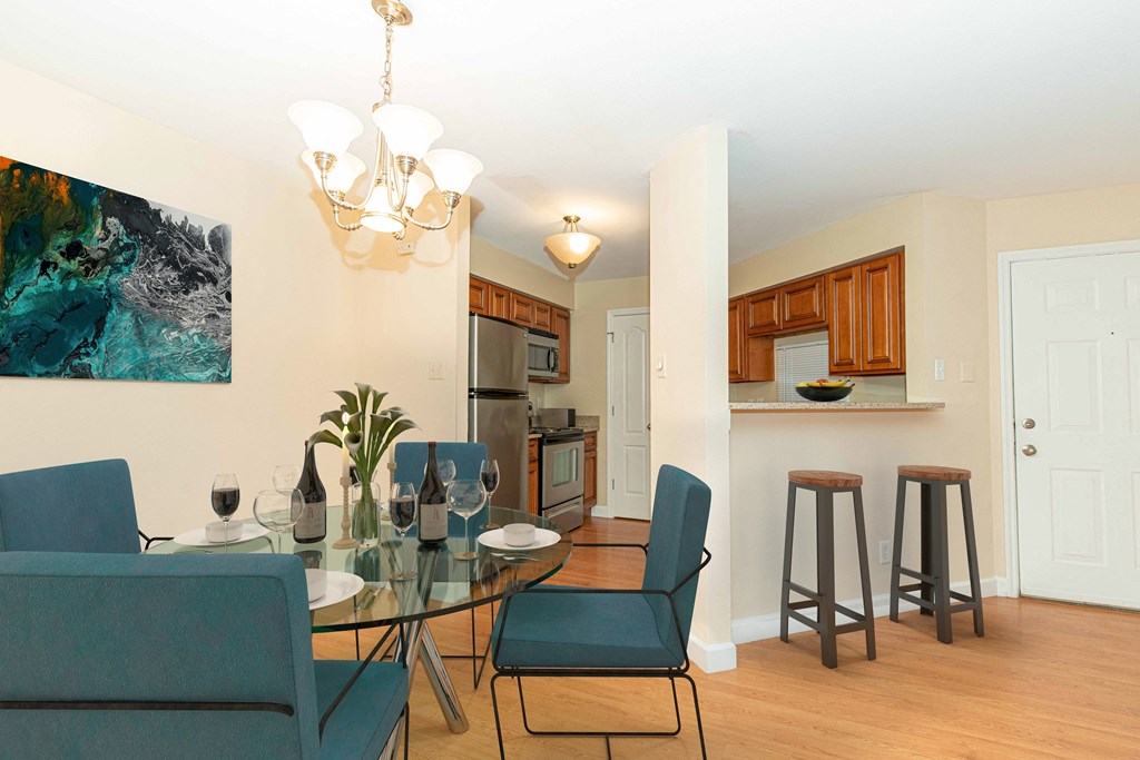 a dining room with a table and chairs and a kitchen
