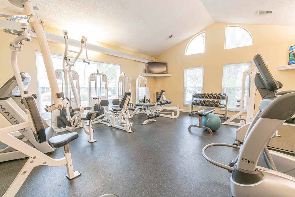 a gym with cardio machines and other exercise equipment