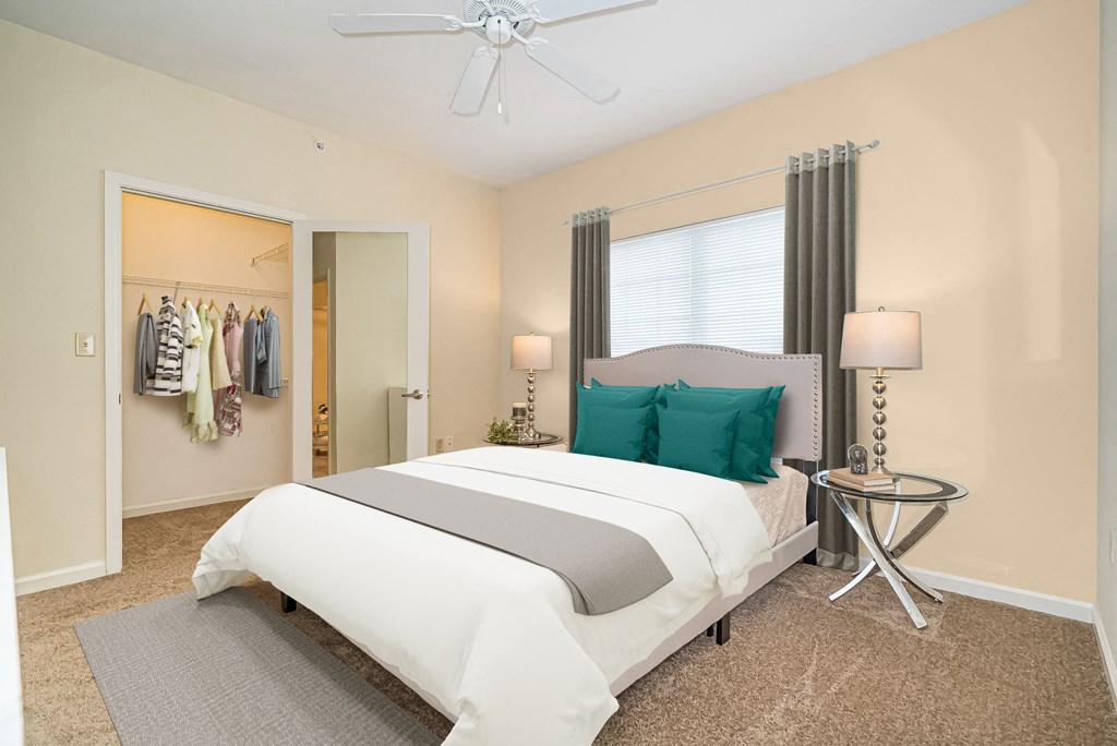 a bedroom with a white bed and a closet