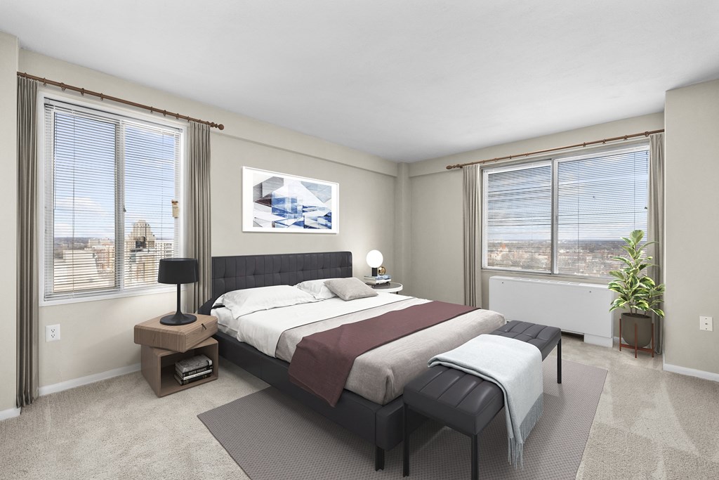 a bedroom with a bed and two windows