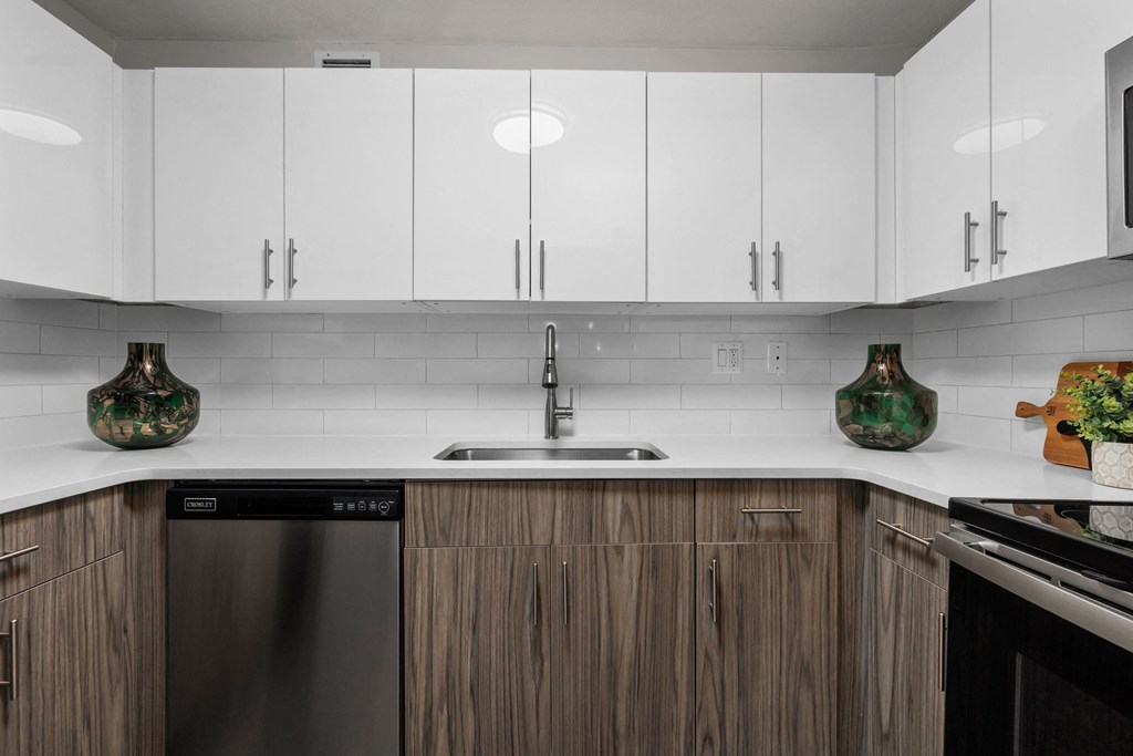 a kitchen with white countertops and wooden cabinets