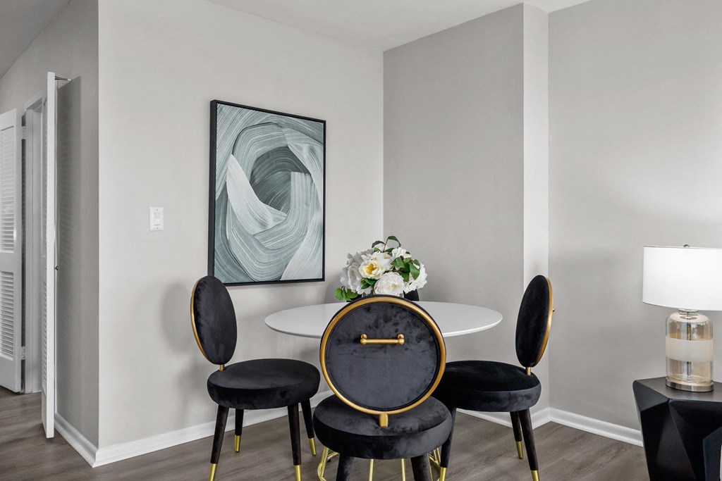 a dining room with a table and four chairs