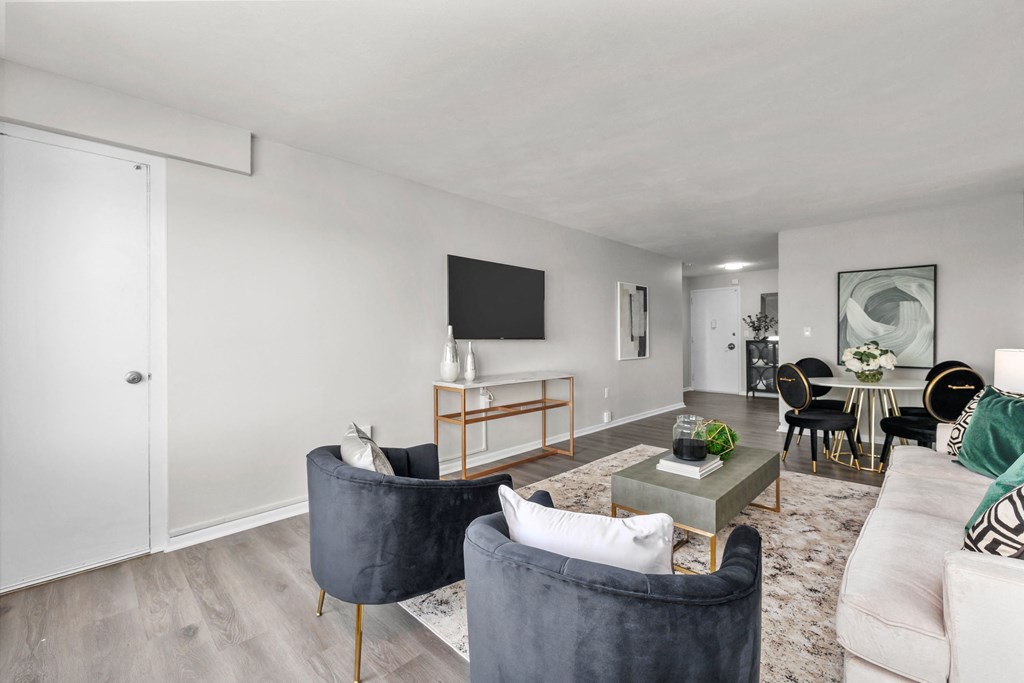 a living room with white walls and hardwood flooring