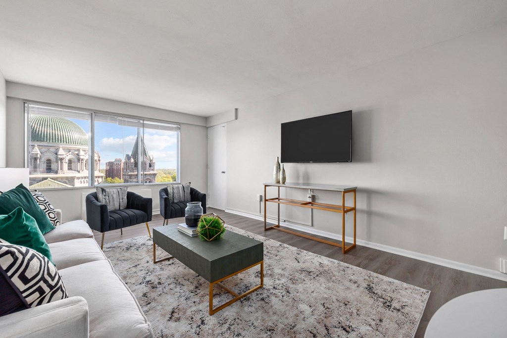 a living room with white walls and a large window