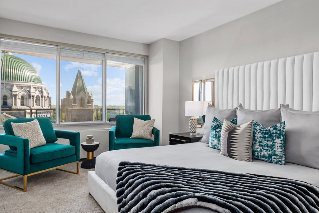 a bedroom with a large bed and a window