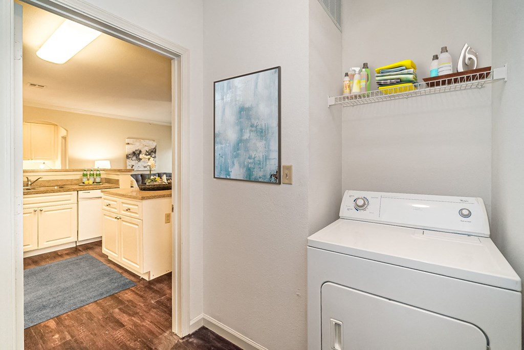 a white washer and dryer in a room with a kitchen