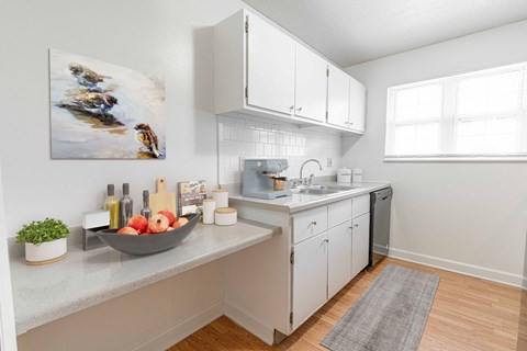 a kitchen with white cabinets and a sink