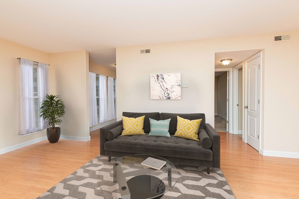 a living room with a couch and a glass coffee table