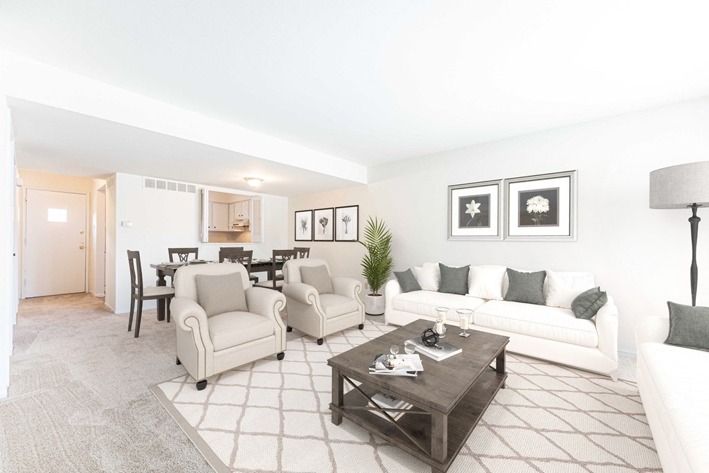 a living room with couches and chairs and a table