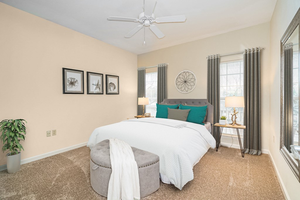 a bedroom with a large bed and a ceiling fan