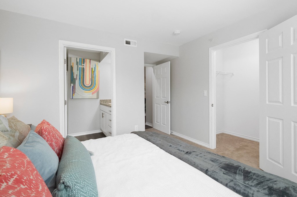 a bedroom with a large bed and a bathroom