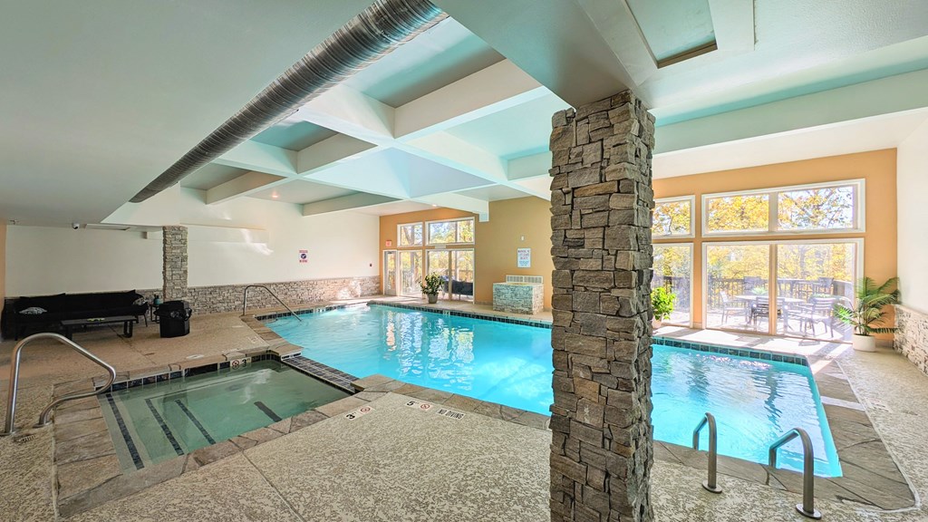 a swimming pool in a room with a large window