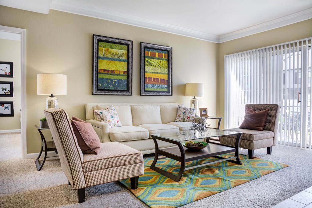 a living room with a couch and chairs and a table