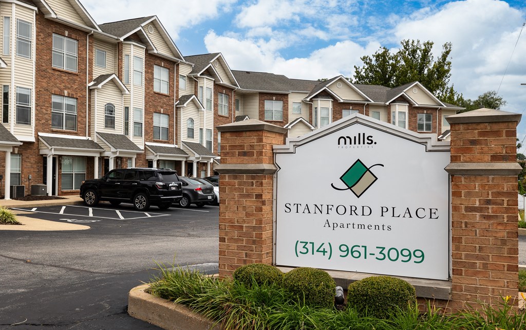 an apartment building with a sign for mills place apartments
