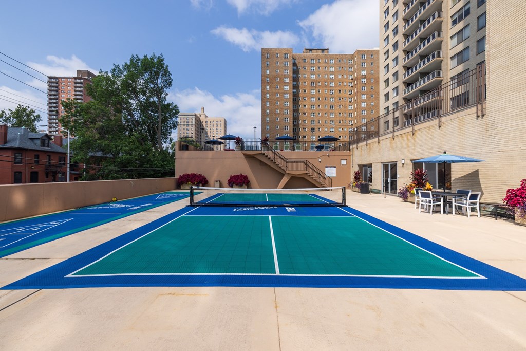 a blue and green tennis court on the roof of a building