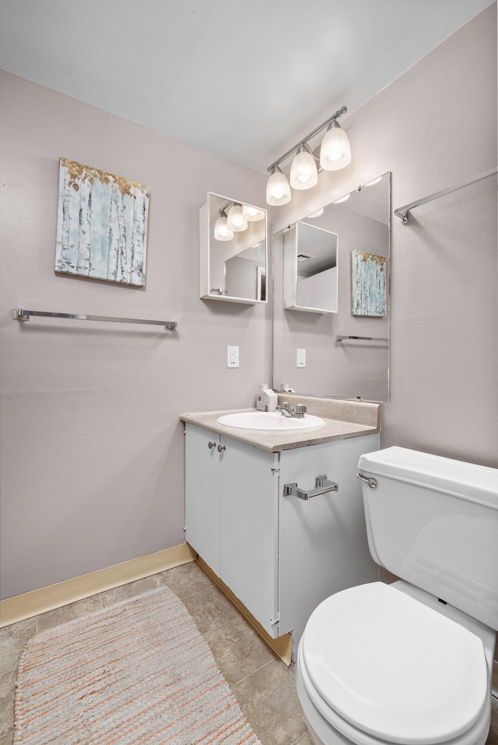 a bathroom with a sink toilet and mirror