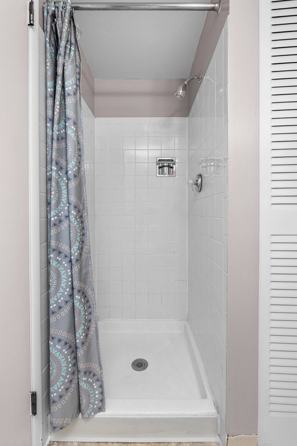 a bathroom with a shower and a curtain