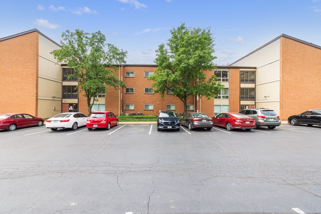 a large brick building with a parking lot in front of it