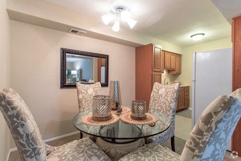 a dining room with a glass table and chairs