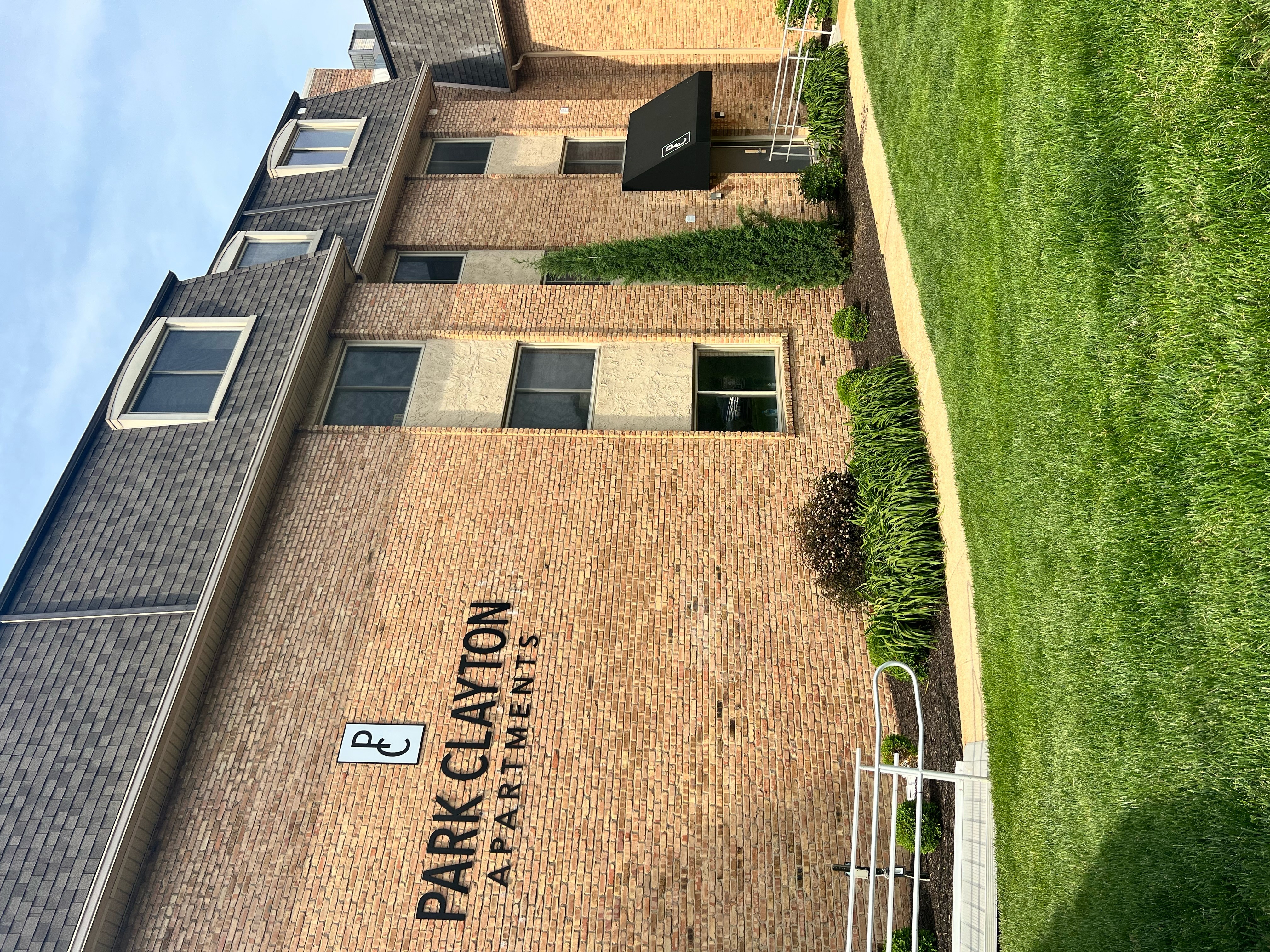 an aerial view of the side of a building with grass