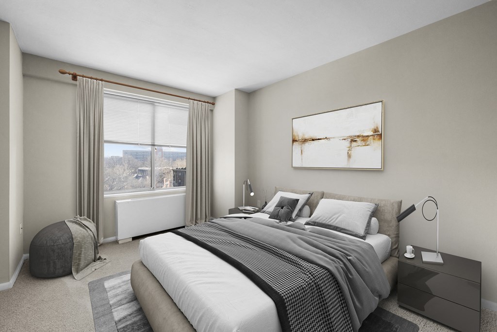 a bedroom with a bed and a large window