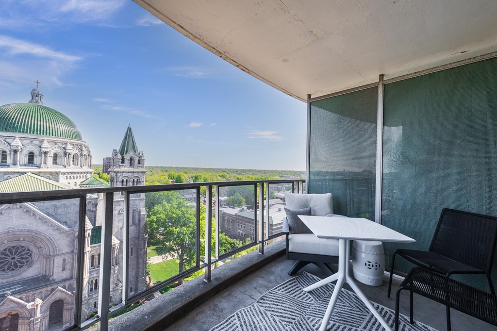 an apartment with a balcony and a view of the basilica of the sacre coeur