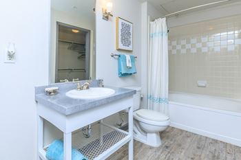 A bathroom with a white sink and toilet.