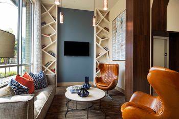 a living room with chairs and a couch and a television