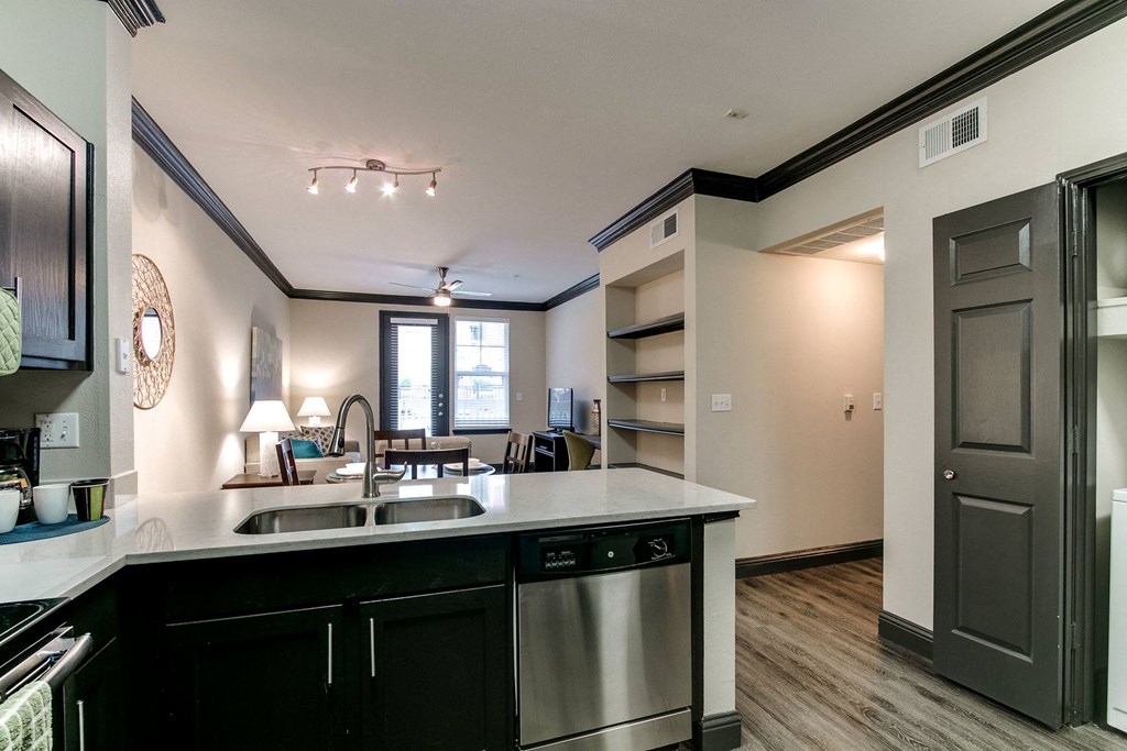 the view of a kitchen and living room from the counter top of a counter top