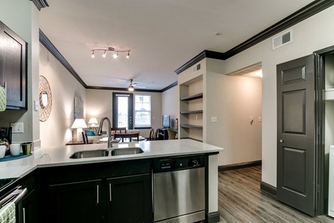 the view of a kitchen and living room from the counter top of a counter top