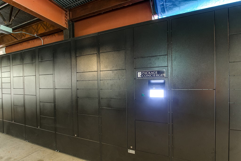 a black wall with a door with a light on it