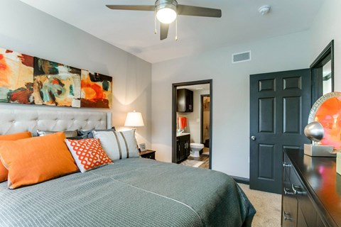 a bedroom with a bed and a ceiling fan