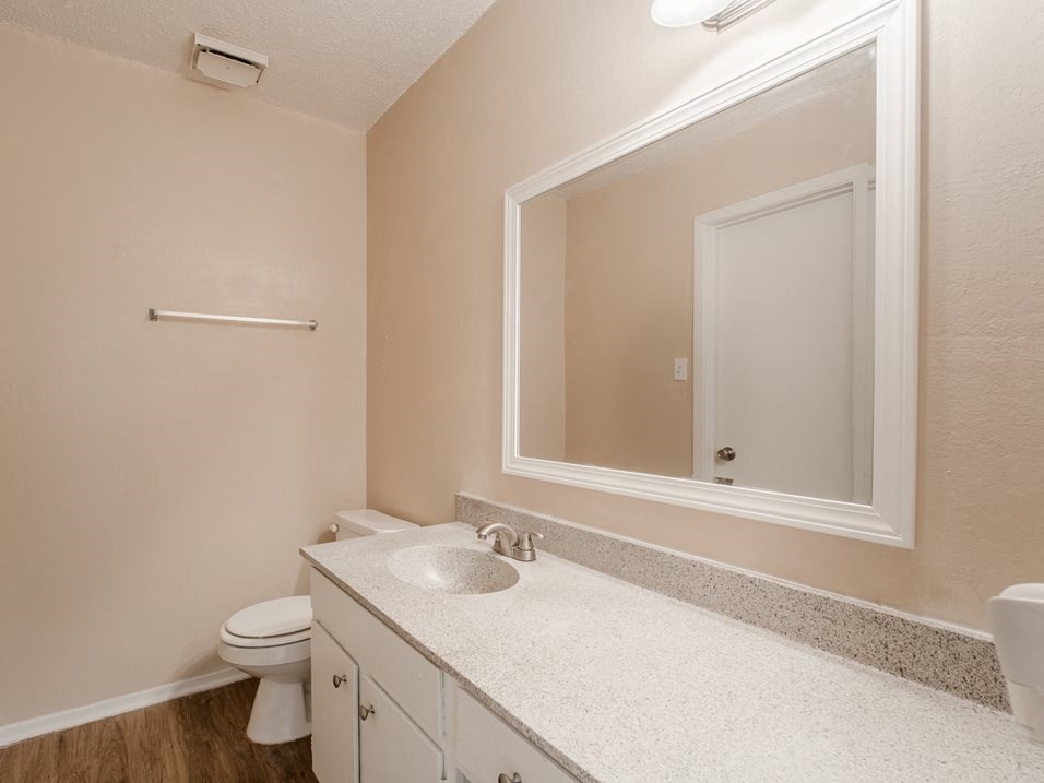 a bathroom with a toilet sink and a mirror