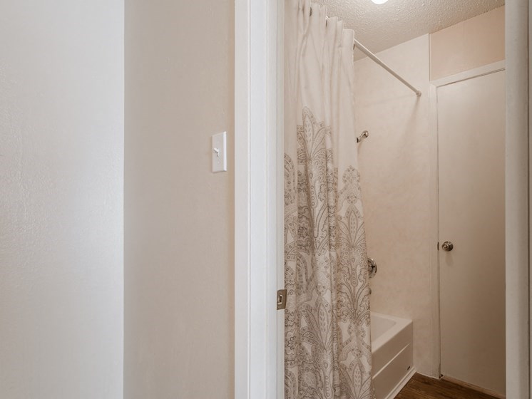 a bathroom with a shower curtain and a sink