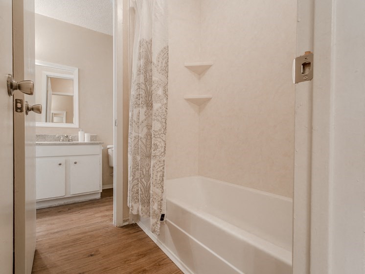 a bathroom with a shower and a sink and a tub