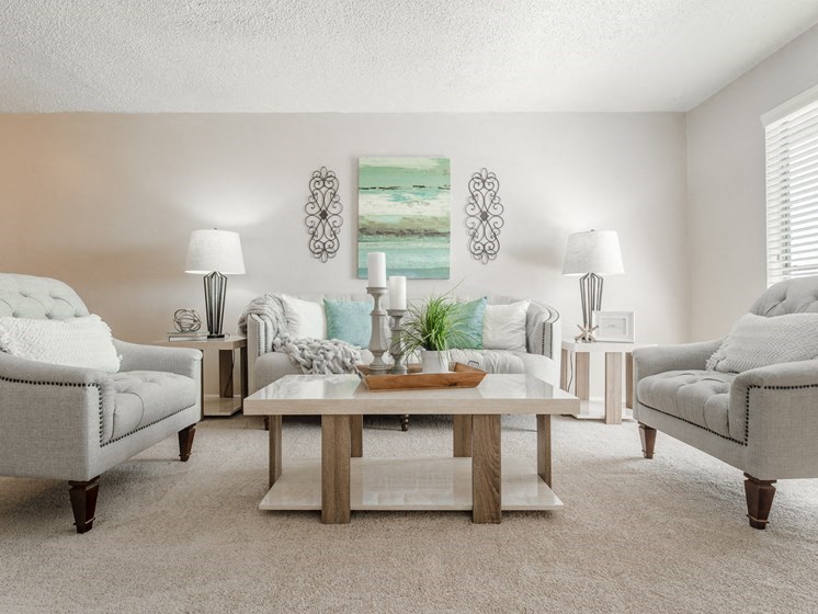 a living room with couches and chairs and a table
