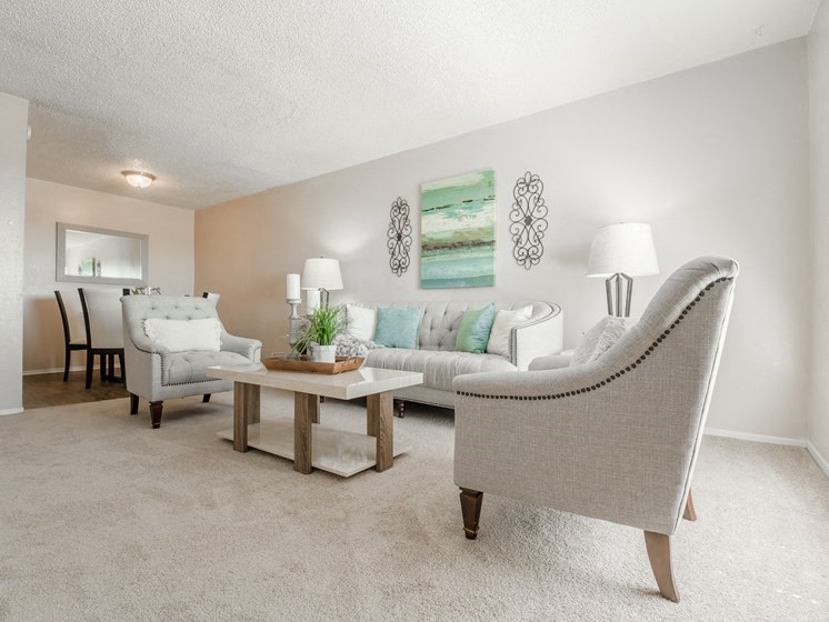 a living room with couches and chairs and a table