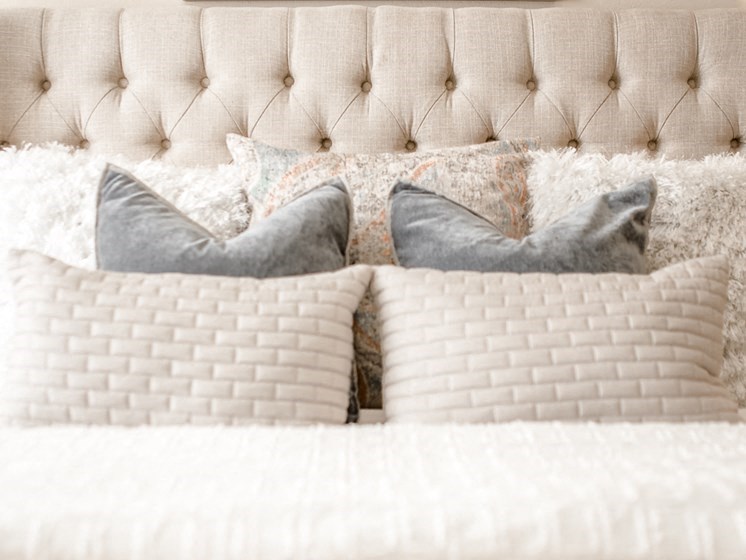 a bed with pillows on top of it