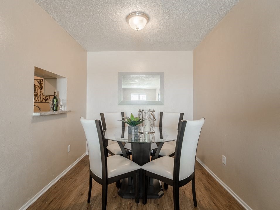 our apartments have a dining room with a glass table and chairs