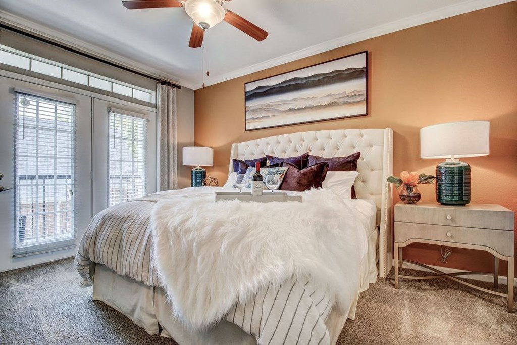 a bedroom with a bed and a ceiling fan