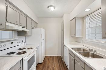 a kitchen with white appliances and white cabinets
