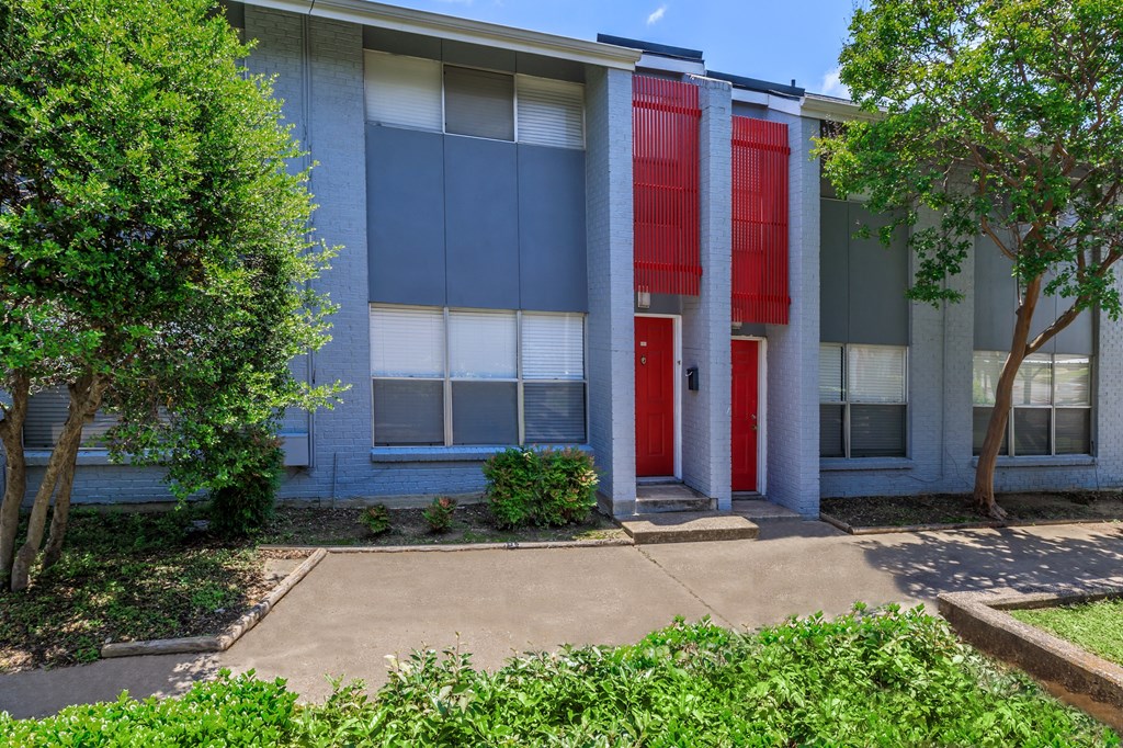 the front of a building with a red door