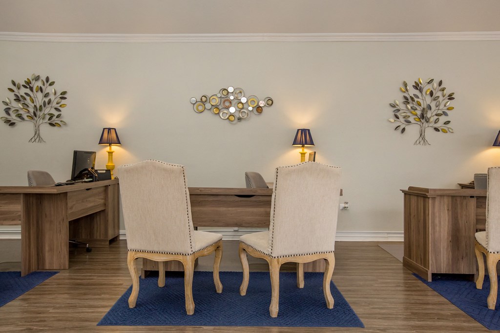 a dining room with two chairs and a table